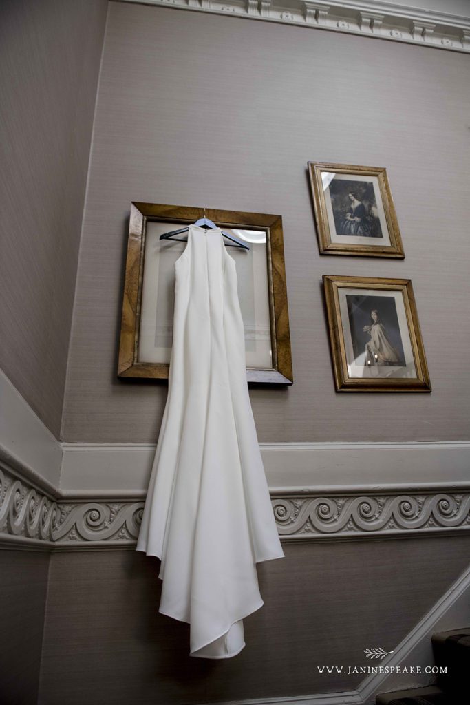 Wedding dress hanging on painting at Sweeney Hall